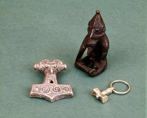 Amulets of Viking Deities: Silver Hammers Symbolizing Thor and Statuette Representing Freyr