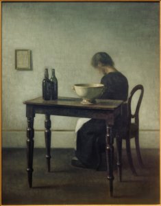 Woman Sitting Behind a Table