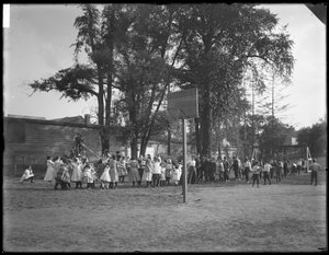 Boys and girls playing tug-o-war on an unidentified playground, c.1910
