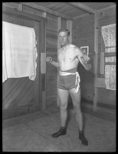 English Boxer William Thomas Wells (Bombardier Billy Wells), Posing in Training Togs with Weight Pulleys, c.1911