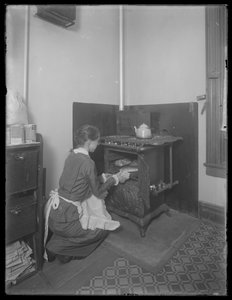 Miss Bates taking bread from the oven by William Davis Hassler