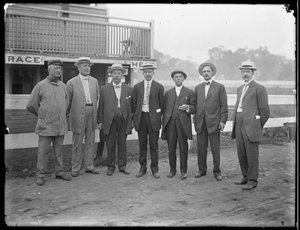 Seven Unidentified Men Pose Near a River or Lake