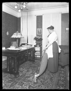 Unidentified woman demonstrating the use of the Apex vacuum cleaner, c.1913-14 by William Davis Hassler