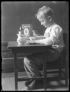 William Gray Hassler Seated at a Small Table Eating a Bowl of Quaker Puffed Rice Cereal, c.1912