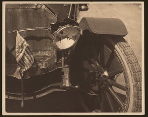Close-up of Damaged Headlight and Grill on Automobile by William G. Swekosky