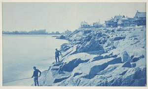 Two Men Fishing from Rocks at Seaside Resort by William H. Cades