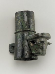 Hubcap with linchpin cast in the form of a feline head by Zhou Dynasty Chinese School