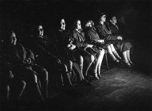 Children at the cinema watching a Walt Disney film
