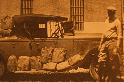 Hams - six-bottles packets in straw and paper for padding in burlap, during Prohibition by American Photographer