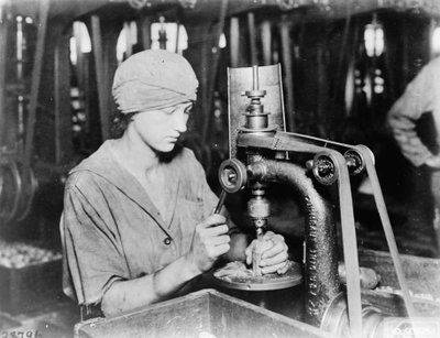 Woman countersinking detonator tube hole and filling hole in hand grenade at Westinghouse Electric & Mfg. Co., East Pittsburgh, Pa., during World War I by American Photographer