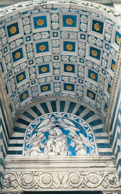Central vault of portico, with blue coffering and gilded rosettes, and lunette above, with glazed earthenware relief of Madonna and Child by Andrea Della Robbia