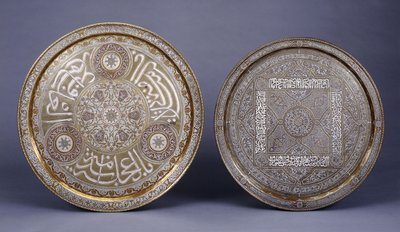 Two gold, copper and silver inlaid brass circular trays, decorated with arabesques and inscriptions, late 19th century by Arabic School