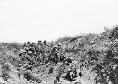 Lieutenant A. V. Sedgwick and some of his party from the 24th Battalion, awaiting the lifting of the artillery barrage on Mont St Quentin, photographed a few minutes before moving out of the trench by Australian Photographer