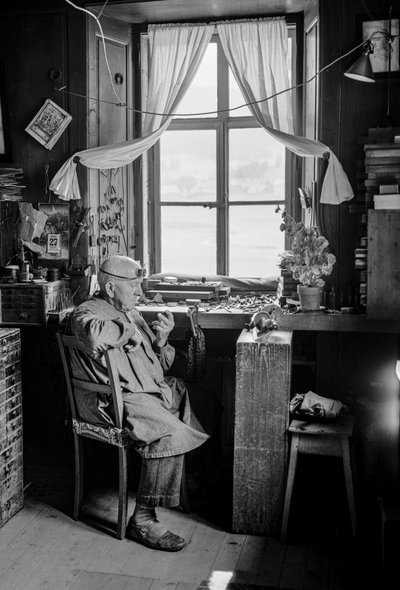 Italian watchmaker with his tools and workbench by Bernard F. Rogers