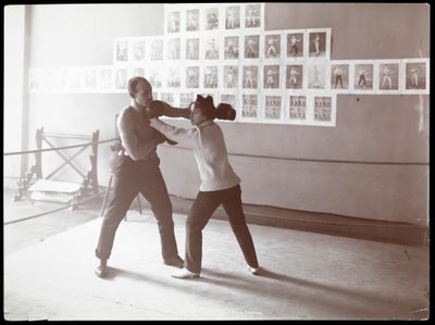 Edna Wallace Hopper posed in a boxing ring with Jack Cooper at his gymnasium at Broadway and 37th Street, New York, 1899 by Byron Company