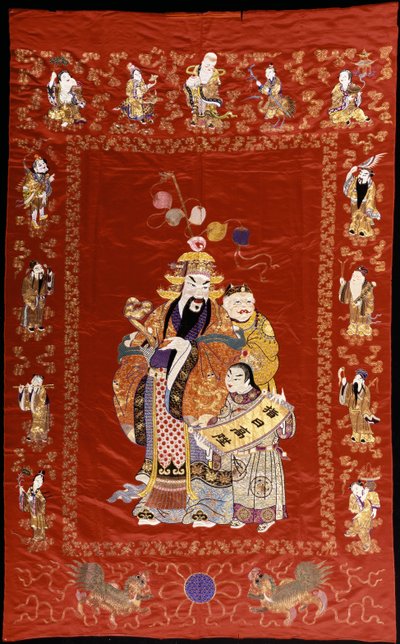 A Chinese Embroidered Red Satin Hanging Depicting a Figure with a Ru-i and Two Attendants, the Borders Decorated with the Eight Immortals by Chinese School