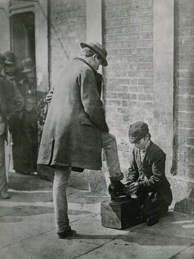 A Young Shoeblack Shining a Man