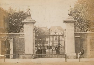 Children Standing Looking Through the School Gate by English Photographer