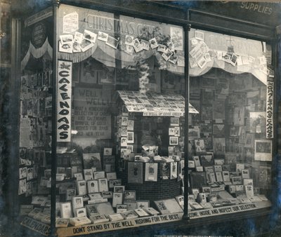 Shopfront displaying Christmas cards and calendars by English Photographer