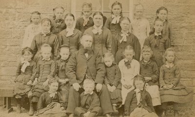 Teacher Posing for a Portrait with His Pupils by English Photographer
