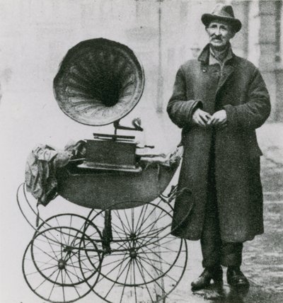 Untitled photograph of man with a phonograph in a pram by English Photographer