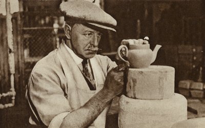 Worker producing a teapot at the Royal Doulton works, Stoke-on-Trent, Staffordshire by English Photographer