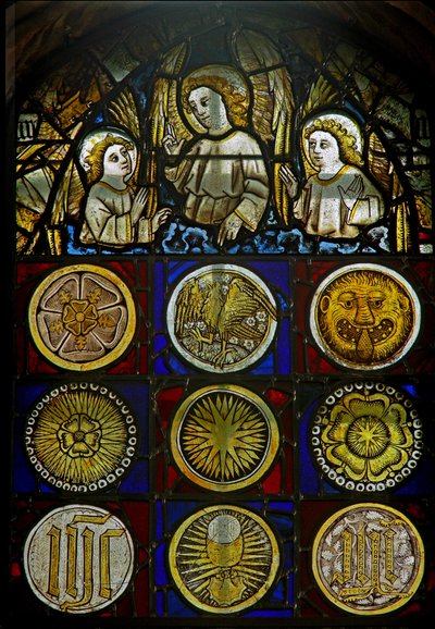 A panel in the east window depicting angels above 9 roundels with sunbursts, roses, a leopard