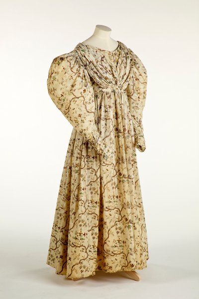 Dress printed with a flower and branch design on cream woven fabric with grid pattern in the weave, c.1830-35 by English School