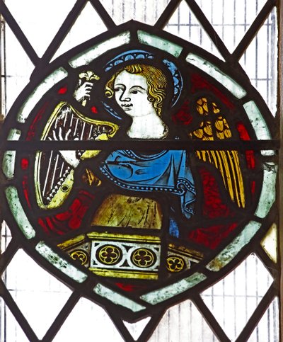 Window n6 depicting an angel with a harp by English School
