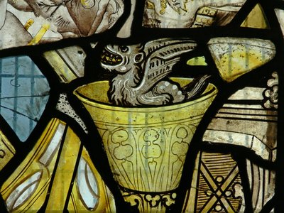 Window depicting a devil in a chalice - probably from a panel of St John by English School