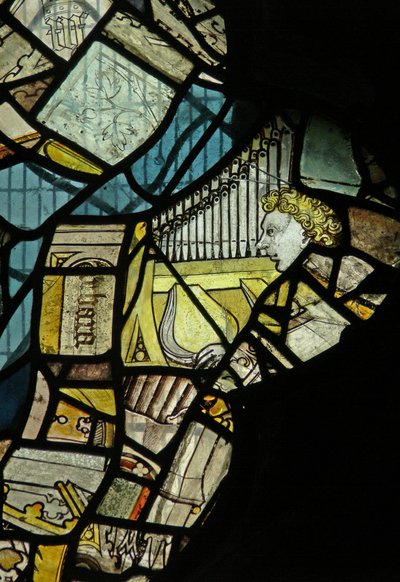 Window depicting fragments including a musician angel with an organ by English School