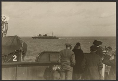 Group of People on the Deck of a Ship Watching Another Ship Sailing Past in the Distance by Erich Salomon