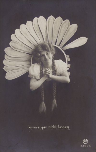 A young woman with long plaits sticks her head through a flower by German School