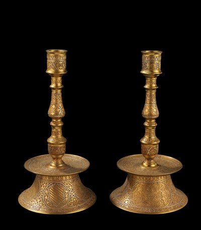 Pair of candlesticks of cast bronze with silver overlay, each with a coat of arms, formerly called 