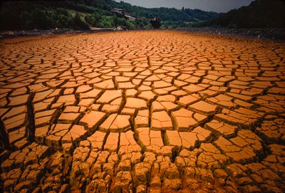 Pond bed left bare after being polluted by a coal mine acid and other waste by James L Stanfield