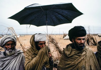 Pakistani Men with an Umbrella and Traditional Garments by James L Stanfield