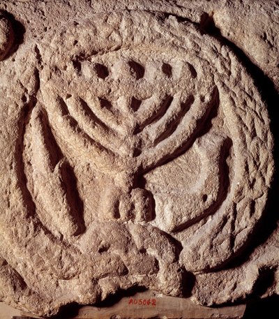 Judaism: architectural element in basalt of a synagogue decorated with a candlestick with seven branches (Menorah), palm and trumpet. From Transjordan. About 100 AD. Paris, Louvre Museum by Jewish School