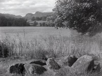 View across Loughrigg Tarn with stones in the foreground by Joseph Hardman