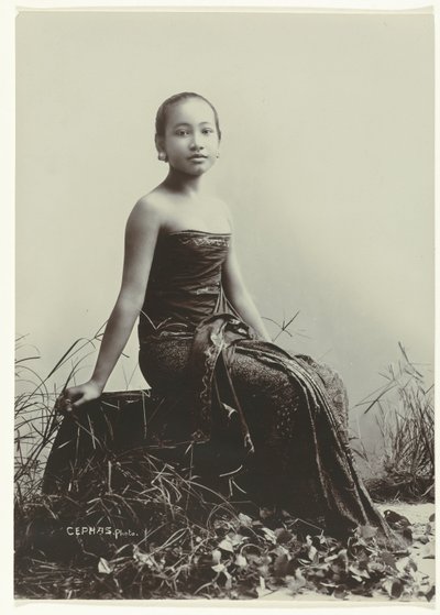 Studio Portrait of a Javanese Woman Sitting on a Log by Kassian Cephas