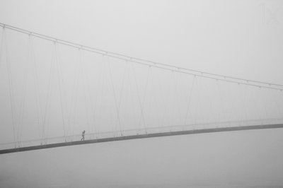 Solitary Walk on Foggy Bridge by Krunoslav Nevistic