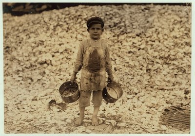 5 Year Old Migrant Shrimp-Picker Manuel in Front of a Pile of Oyster Shells, Working for a Second Year at Dunbar, Lopez, Dukate Company, Biloxi, Mississippi, 1911 by Lewis Wickes Hine
