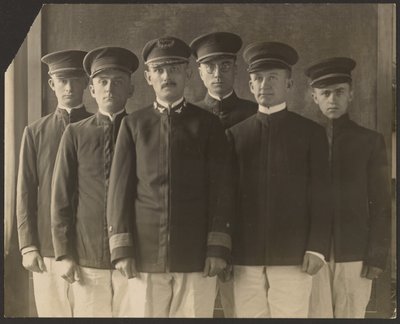 Group of Young Men in Uniform Before Tapestry by Louis Fleckenstein