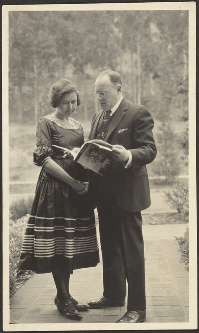 Man and Woman Standing Outside with Magazine by Louis Fleckenstein