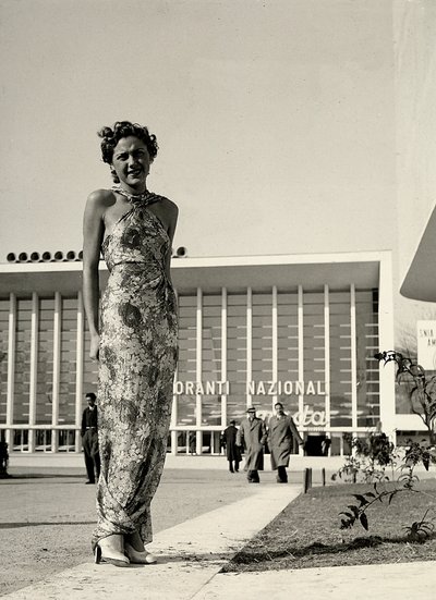 Model wears a long dress with a floral pattern, created by the couture house Graldi by Luis Bogino