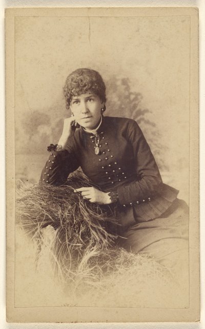 Unidentified Woman Seated with Hand on Cheek, Posed on a Pile of Hay by Miller and Company