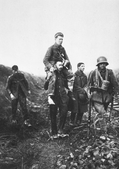 A German Infantry Soldier with a Wounded Leg is Carried from Battle by English Prisoners of War by Photographer German