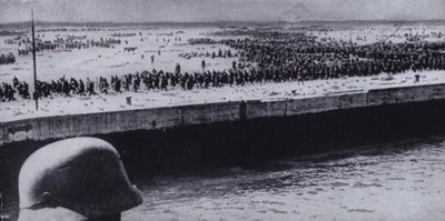 German soldier surveying Allied prisoners on the beach at Dunkirk, France, World War II, June 1940 by Photographer German
