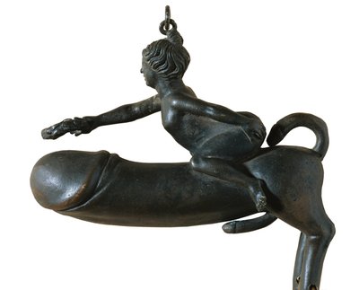 Sasamon Phallus. 1st c. Animal with Chest, Legs and Tail Shaped Glans, Mounted by a Woman with Laurel Wreath. Amulet Against the Evil Eye. Roman Art. Early Empire. Sculpture on Bronze. Spain. Catalonia. Barcelona. Archaeology Museum of Catalonia by Roman Roman