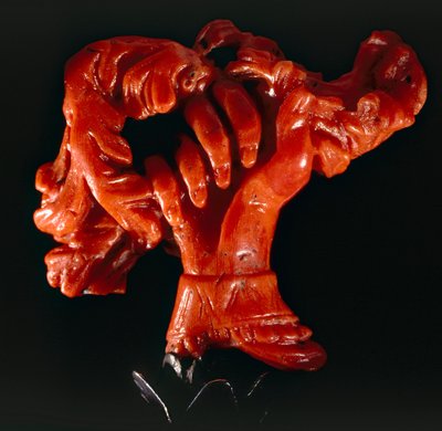 Hand with scroll: small object in coral by Sicilian School