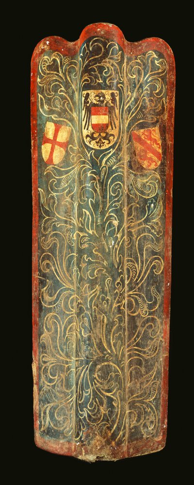 A rare Swiss pavise of wood covered with gesso painted canvas of green scrolling foliage design and the shields of arms of Habsburg, the League of St George, and the town of Winterthur by Swiss School